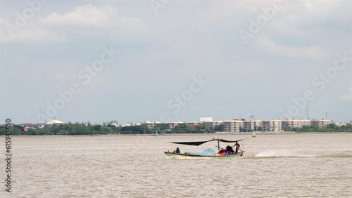Thai fishermen in the Chao Phraya river estuary returning with their catch of fish, Samut Prakan, Thailand photo