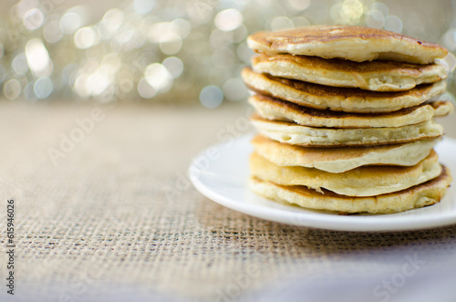 Fried pancakes are a mountain on a plate of sweets for a healthy breakfast