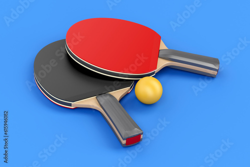 Pair of table tennis rackets and ball on blue background