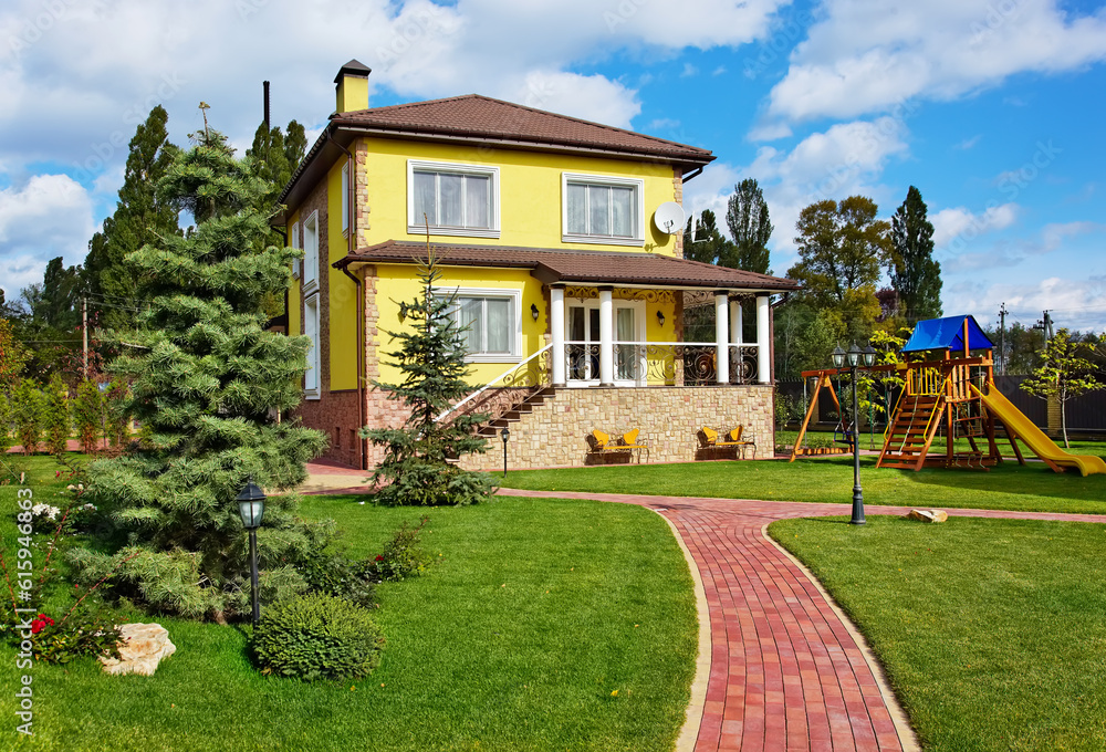 Exterior of luxury home with green yard, trees and children playground