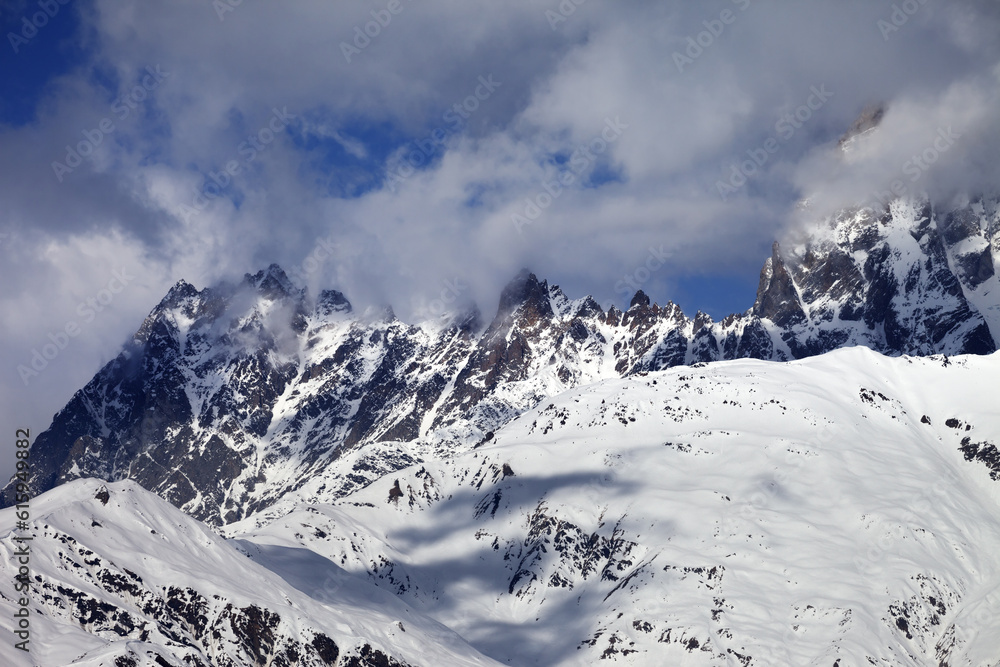 Obraz premium Snowy rocks in haze at sunny day. Caucasus Mountains. Svaneti region of Georgia.