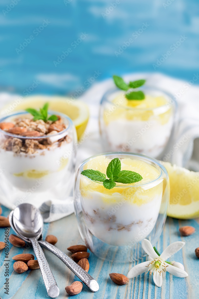 Yogurt with granola, almonds and grapefruit slices on old wooden background Yogurt with granola, almonds and grapefruit slices on old wooden background