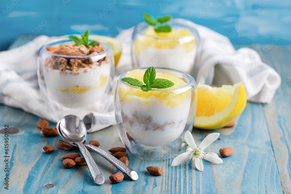 Yogurt with granola, almonds and grapefruit slices on old wooden background Yogurt with granola, almonds and grapefruit slices on old wooden background