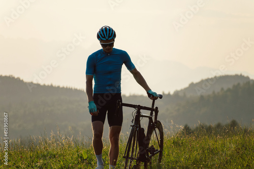 Fototapeta Naklejka Na Ścianę i Meble -  Man road cycling on race bike outdoor in nature
