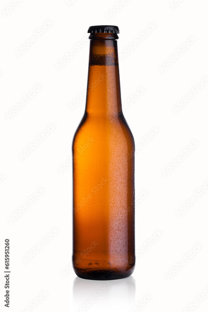 Brown glass lager beer bottle with black cap isolated on white background with dew and reflection