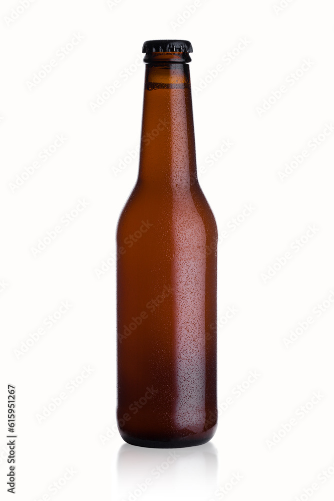 Brown glass lager beer bottle with black cap isolated on white background with dew and reflection Brown glass lager beer bottle with black cap isolated on white background with dew and reflection