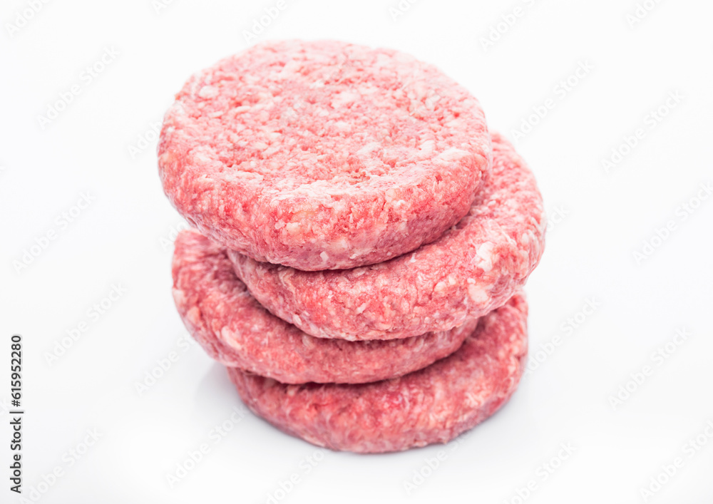Raw fresh beef burgers on white background with reflection Raw fresh beef burgers on white background with reflection