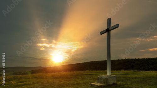Cross on the hill at sunrise