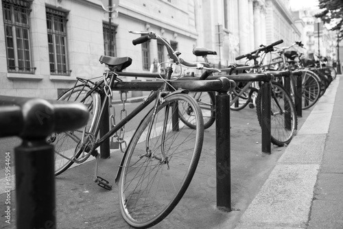 Fototapeta Naklejka Na Ścianę i Meble -  A bunch of bikes tightened on racks on the street of Paris, France.