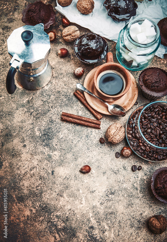 Crafting coffee in clay cup with bean cezve and chocolate cake top view on grunge background. © Designpics