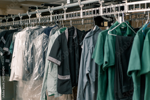 industrial laundry in the hotel clean shirts of employees and guests sorted after washing hang on clotheslines concept of cleanliness and hospitality
