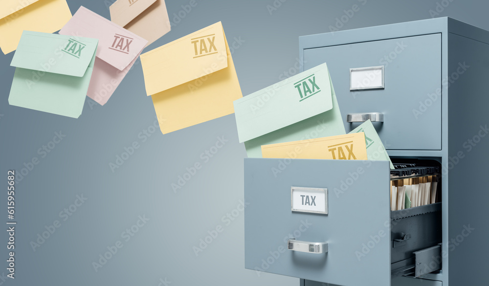 Tax files transferring into a filing cabinet: data storage, tax and accounting concept Tax files transferring into a filing cabinet: data storage, tax and accounting concept