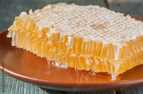 Fresh honeycombs on a wooden table closeup, selective focus
