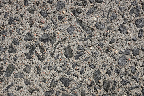 Exposed aggregate concrete paving, with small stones and grit as abstract background texture photo