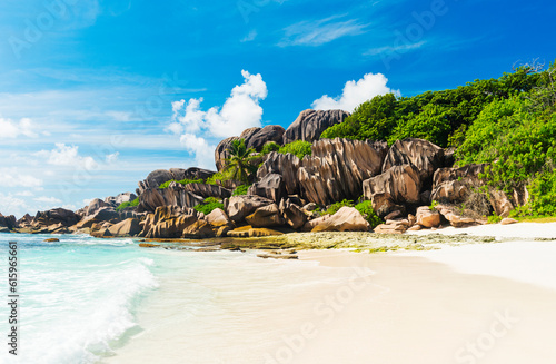 Beautifully shaped granite boulders and a perfect white sand at Grand Anse, La Digue island, Seychelles photo