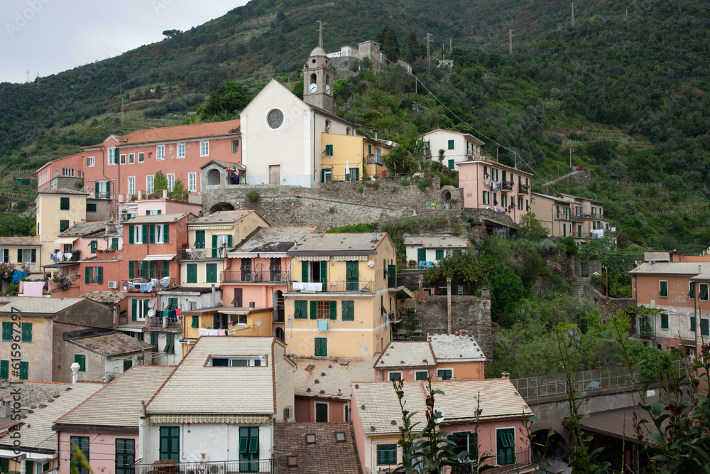 Church on hill and rooftops in high density housing in hillside historic Italian fishing village