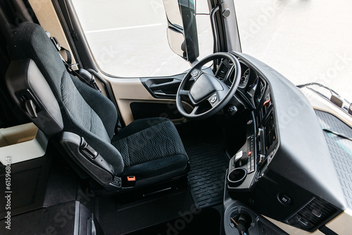 The interior of the cabin of a new modern truck. steering wheel, pedals, seat included, multimedia