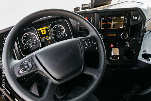 Semi Truck Interior View of Drivers Cockpit showing the controls and Navigation Equipment and Camera Screens © AvokadoStudio