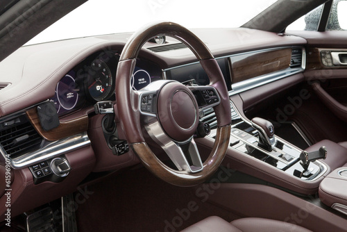 interior of a luxury sports grand coupe with designer leather and wood trim © AvokadoStudio