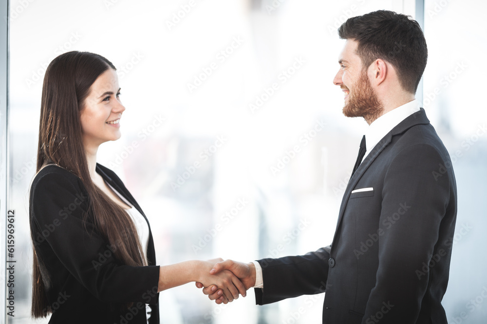 Business people shaking hands, finishing up a meeting in the office