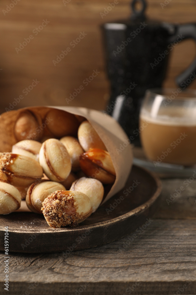 Freshly baked homemade walnut shaped cookies on wooden table, closeup Freshly baked homemade walnut shaped cookies on wooden table, closeup