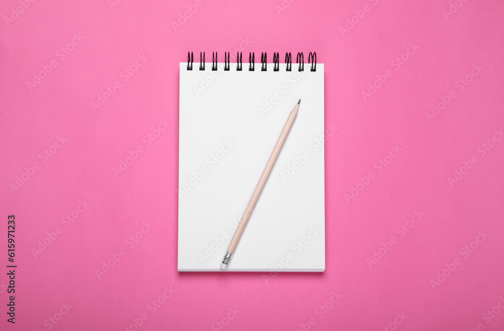 Blank notebook and pencil on pink background, top view Blank notebook and pencil on pink background, top view