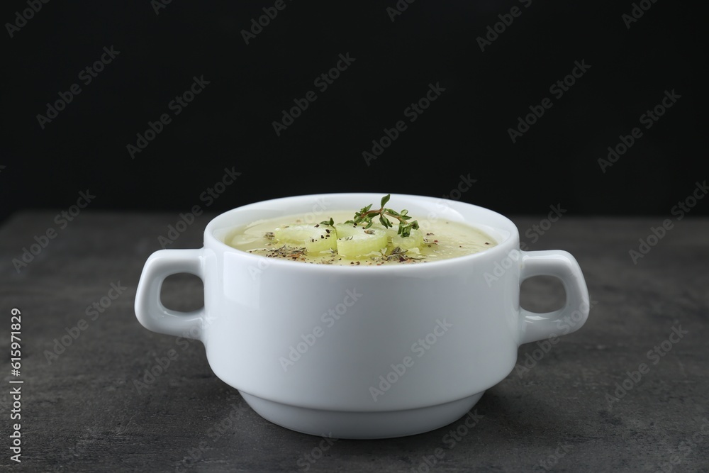 Bowl of delicious celery soup on gray table Bowl of delicious celery soup on gray table