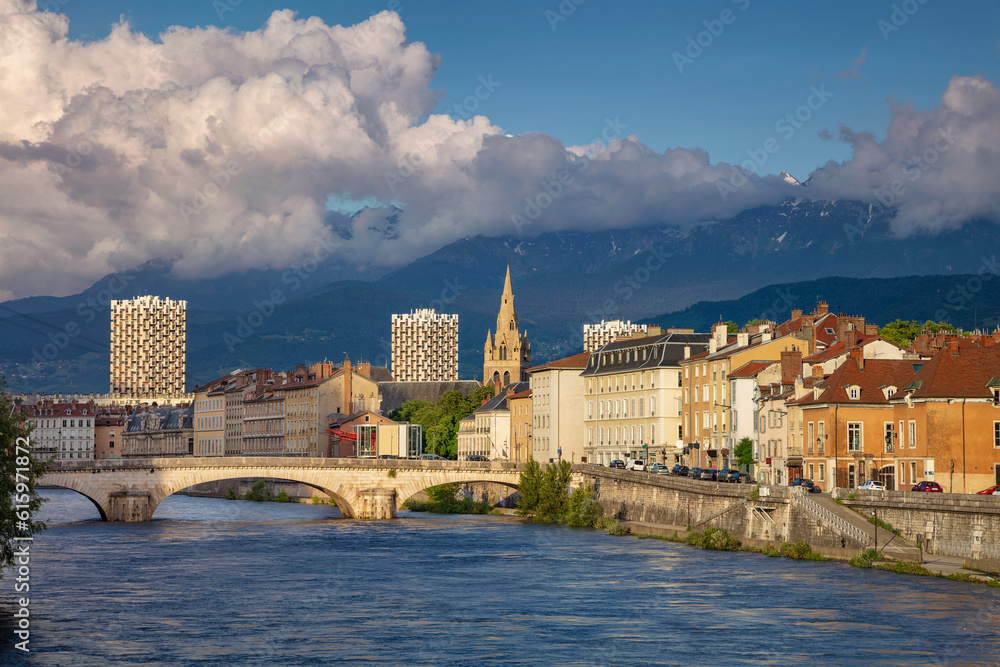 Obraz premium Cityscape image of Grenoble, France during sunset.