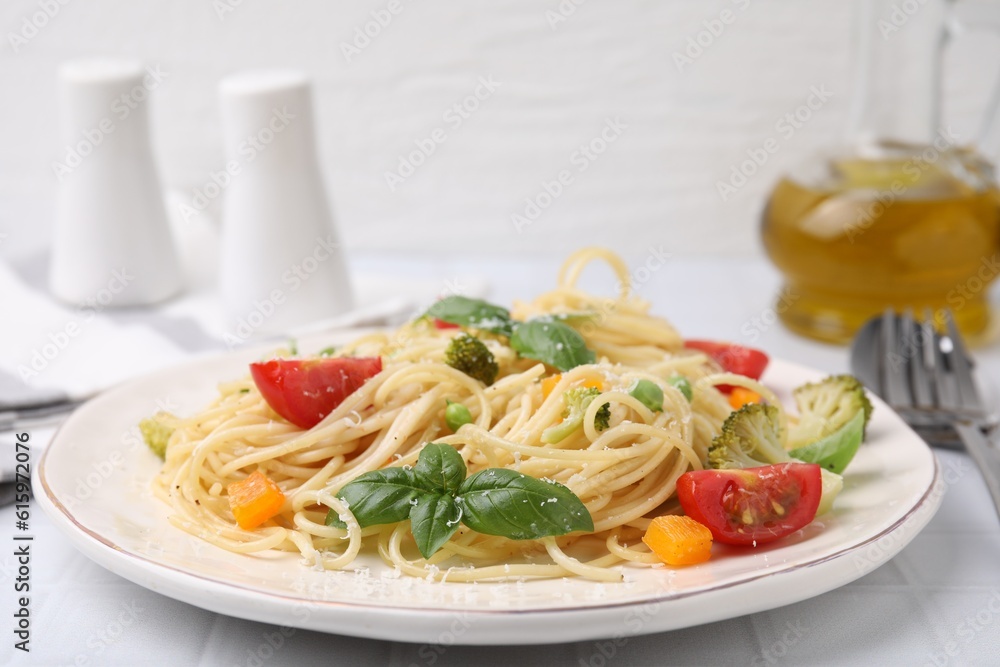 Delicious pasta primavera with tomatoes, basil and broccoli on white table, closeup