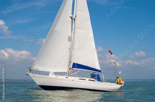 Sailing boat, sail boat or yacht at sea with white sails