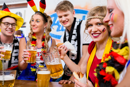 Football fans watching a game of the German national team drinking beer