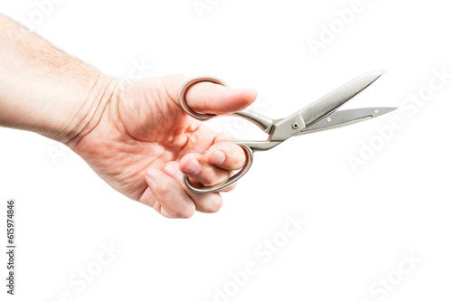 Male hand holds a large open metal scissors isolated on a white background