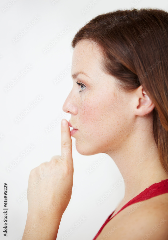 Secret, hand and woman with finger on lips in studio for gossip, privacy or sign on white background. Whisper, profile and female person with silence, confidential or emoji with drama or announcement Secret, hand and woman with finger on lips in studio for gossip, privacy or sign on white background. Whisper, profile and female person with silence, confidential or emoji with drama or announcement