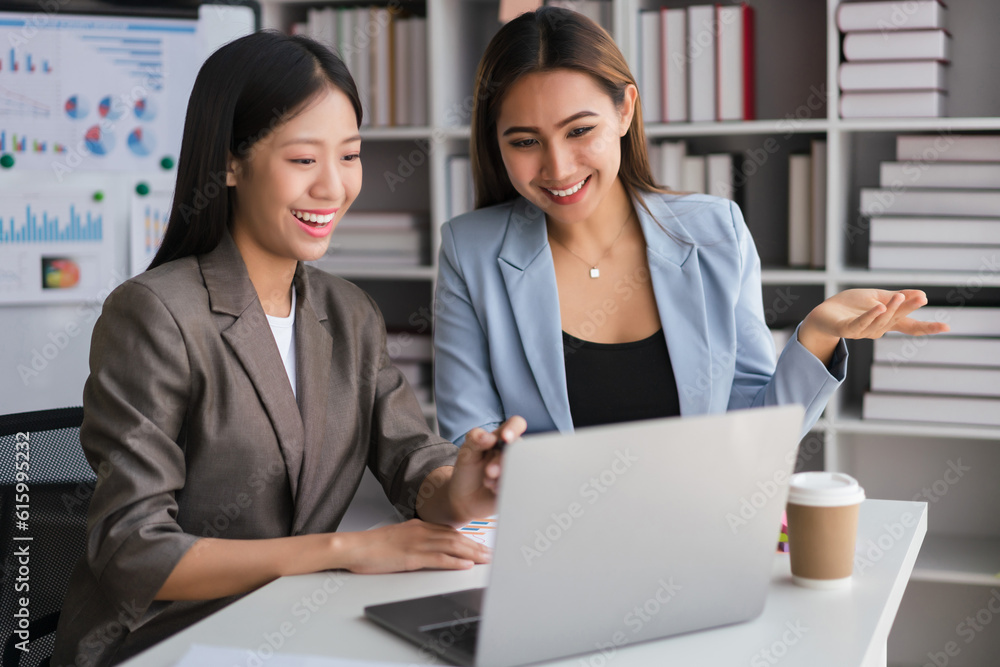 Two businesswomen working on laptop to discussion and brainstorming about strategy of new business Two businesswomen working on laptop to discussion and brainstorming about strategy of new business