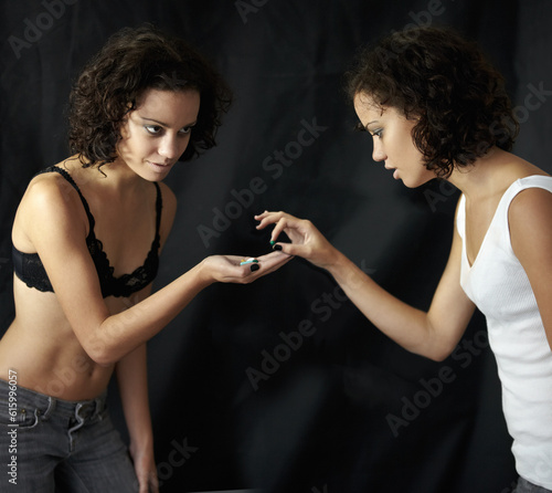 Diet, pills and woman with anorexia in studio for mental health, crisis or problem on black background. Weight loss, medication and obsession by lady with body dysmorphia, bulimia or eating disorder photo