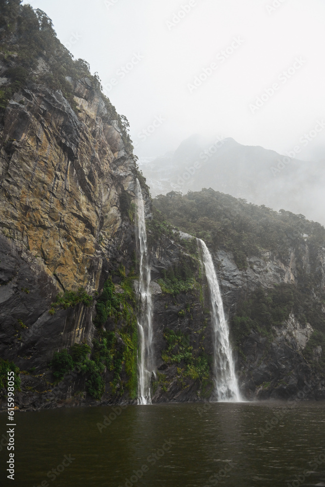 Water falls down waterfalls in the The River Cleddau in Milford Sound, in the South Island of New Zealand