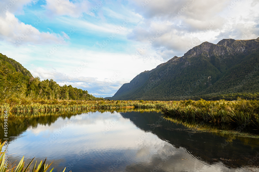 A view of a mountain range over the back of a lake in the late afternoon in Southland, New Zealand