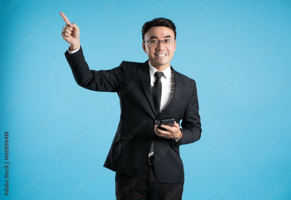 image of young businessman using phone on blue background image of young businessman using phone on blue background