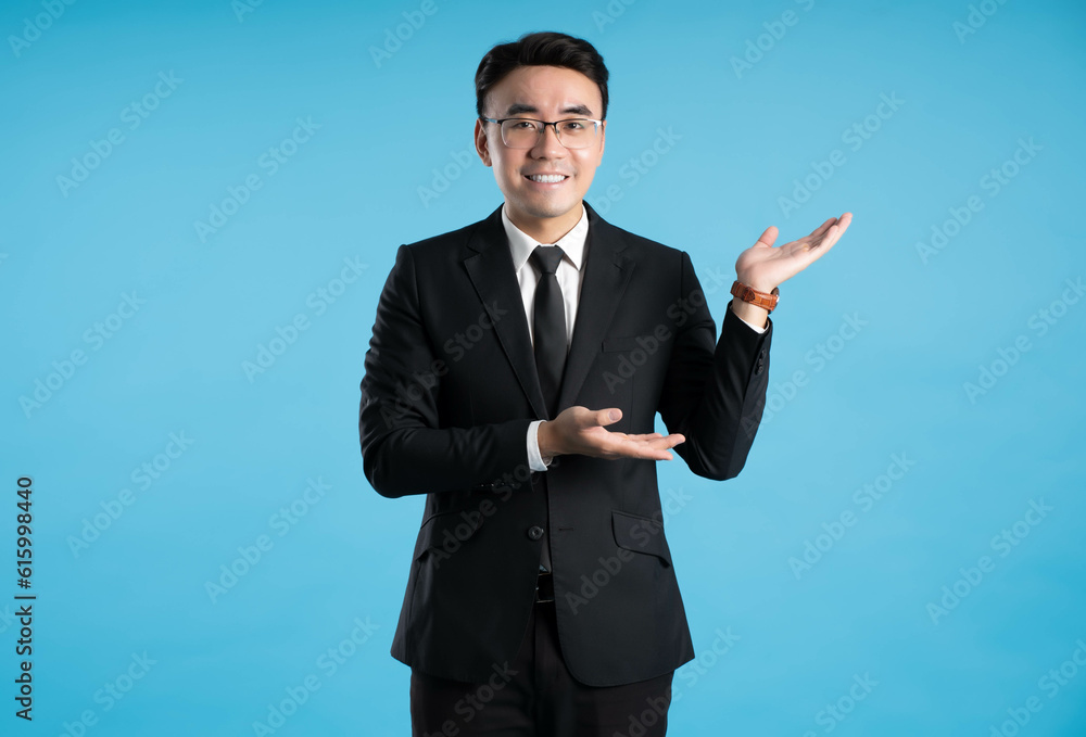 image of young businessman posing on blue background image of young businessman posing on blue background