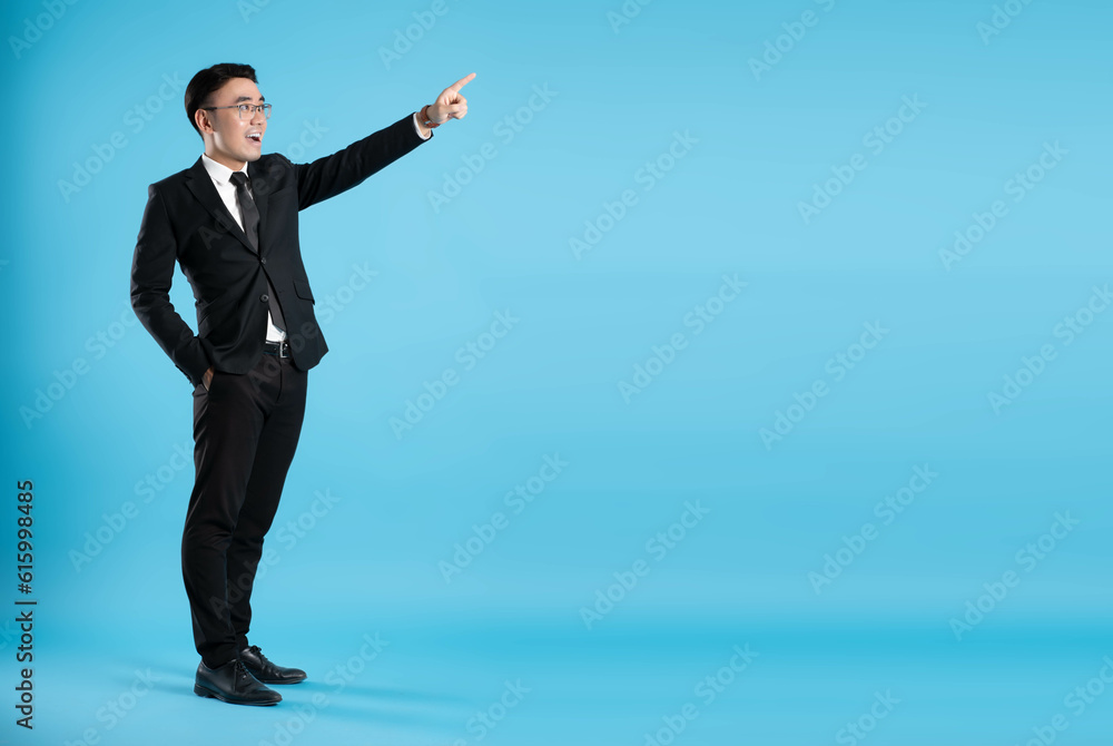 full body image of young businessman posing on blue background full body image of young businessman posing on blue background