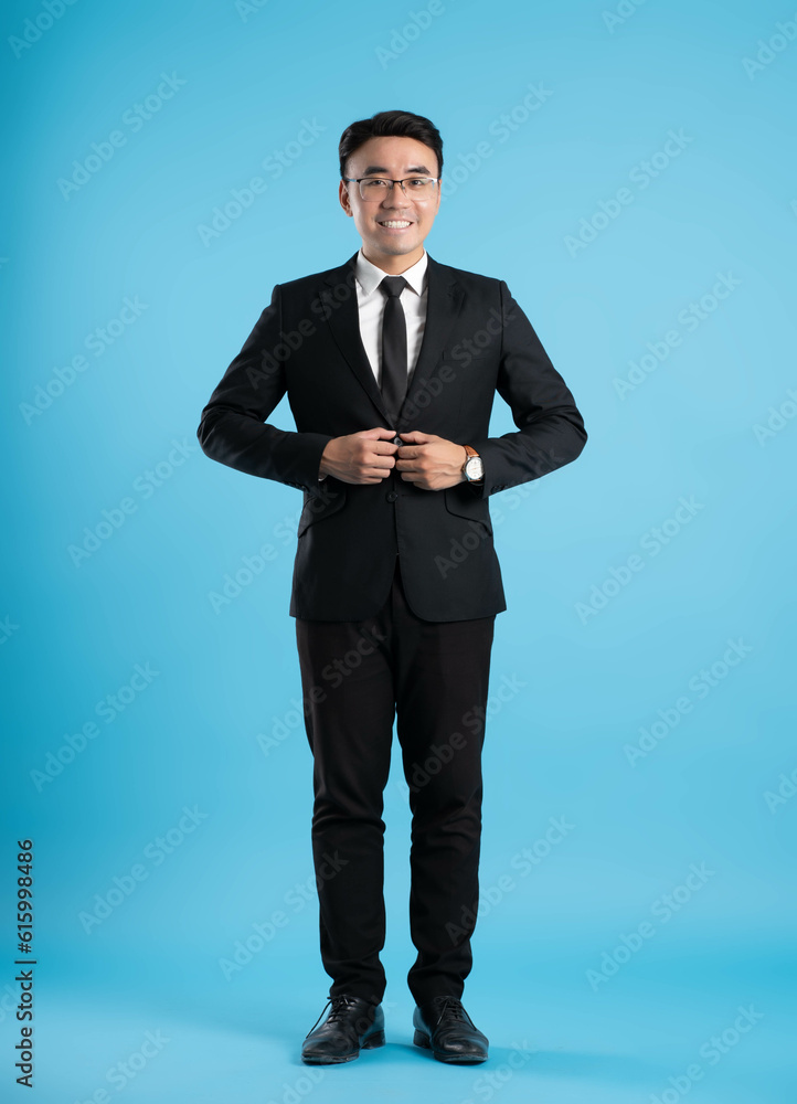 full body image of young businessman posing on blue background full body image of young businessman posing on blue background