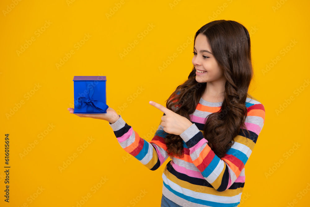 Teenager child with gift box. Present for holidays. Happy birthday, Valentines day, New Year or Christmas. Kid hold present box. Happy teenage girl, positive and smiling emotions. Teenager child with gift box. Present for holidays. Happy birthday, Valentines day, New Year or Christmas. Kid hold present box. Happy teenage girl, positive and smiling emotions.