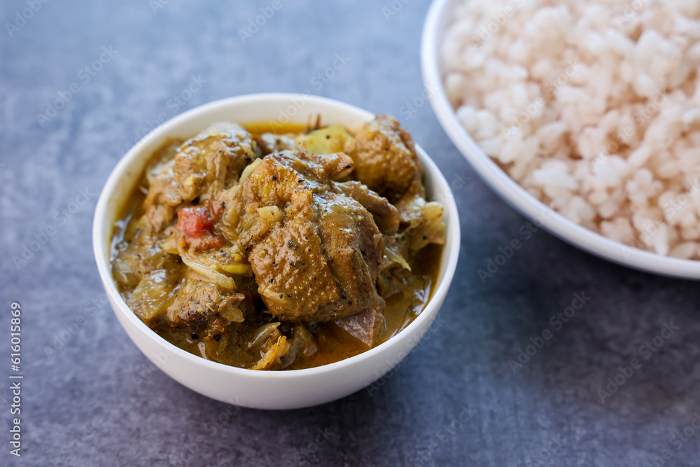 A traditional duck curry roast. Kerala style duck or chicken curry with coconut milk for appam rice. Indian food in black background. A traditional duck curry roast. Kerala style duck or chicken curry with coconut milk for appam rice. Indian food in black background.