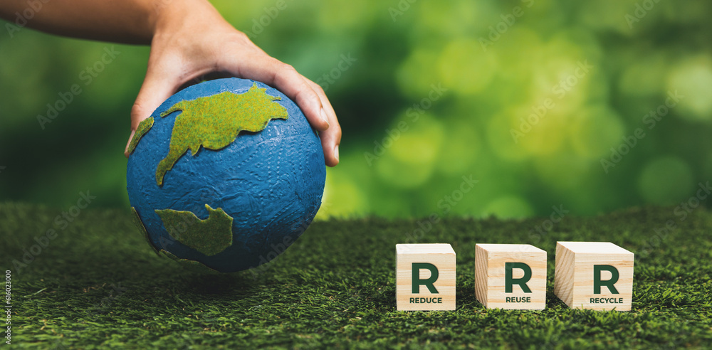 Businessman hand with paper globe and Reduce Reuse Recycle symbol cube ...