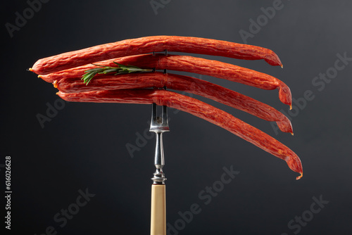 Smocked sausages on a black background. photo