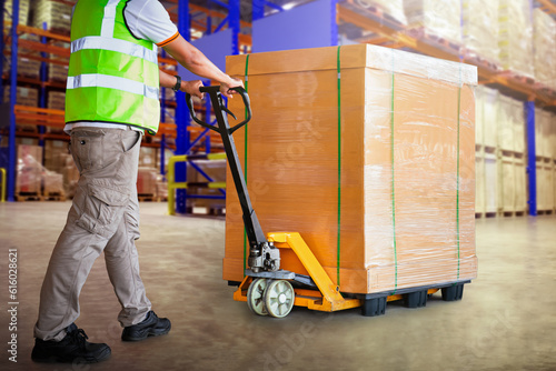 Workers Unloading Heavy Package Boxes in Storage Warehouse. Forklift Pallet Jack Loader. Shipping Supplies. Supply Chain Shipment Goods. Distribution Warehouse Logistic. photo