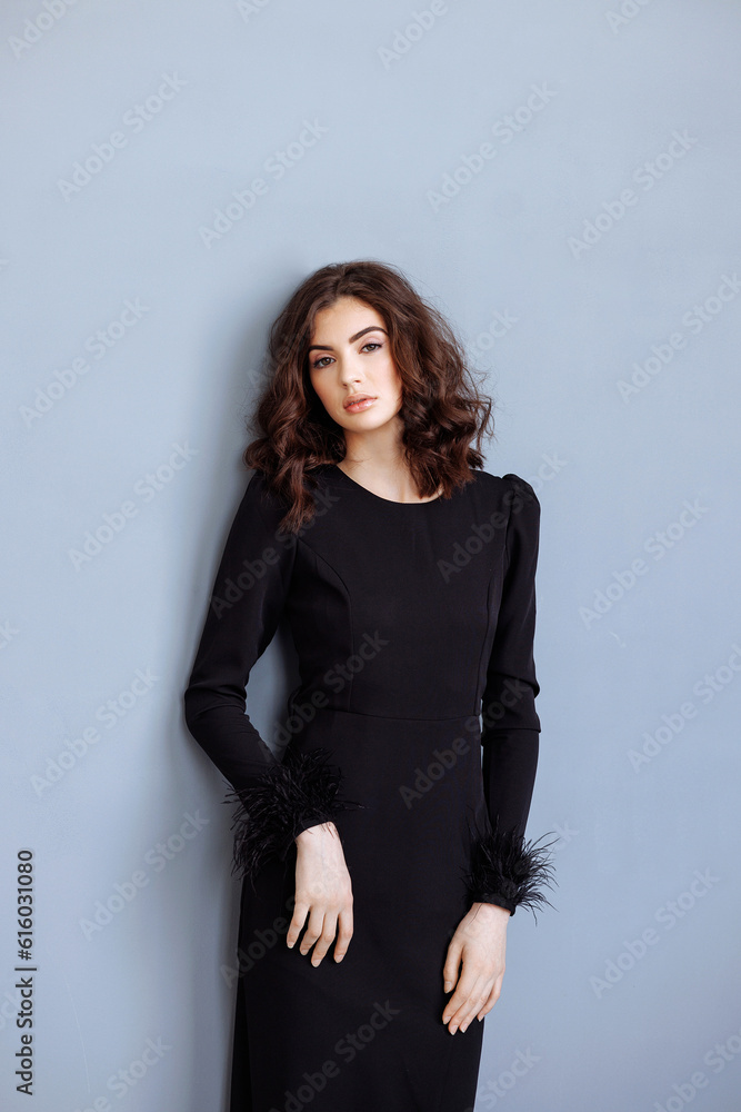Close-up portrait of young beautiful brunette woman in black. Long hair, clear skin and attractive eyes. Close-up portrait of young beautiful brunette woman in black. Long hair, clear skin and attractive eyes.