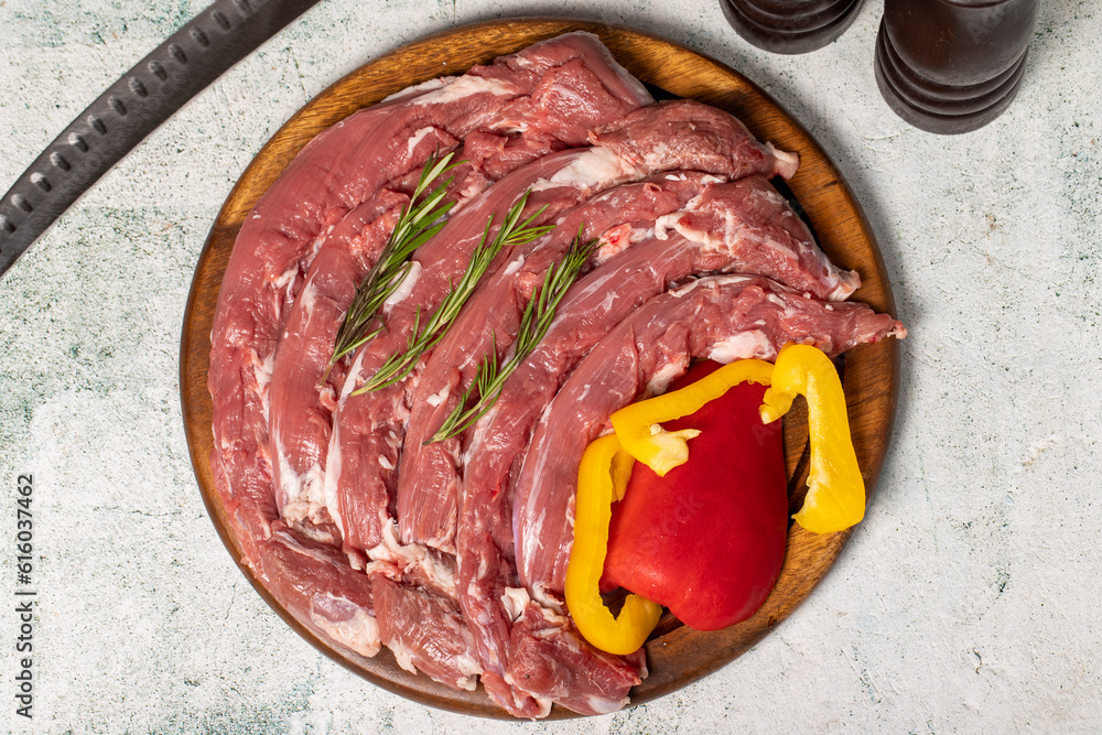 Lamb tenderloin or mutton sirloin. Fresh raw lamb tenderloin on a wood serving board Lamb tenderloin or mutton sirloin. Fresh raw lamb tenderloin on a wood serving board