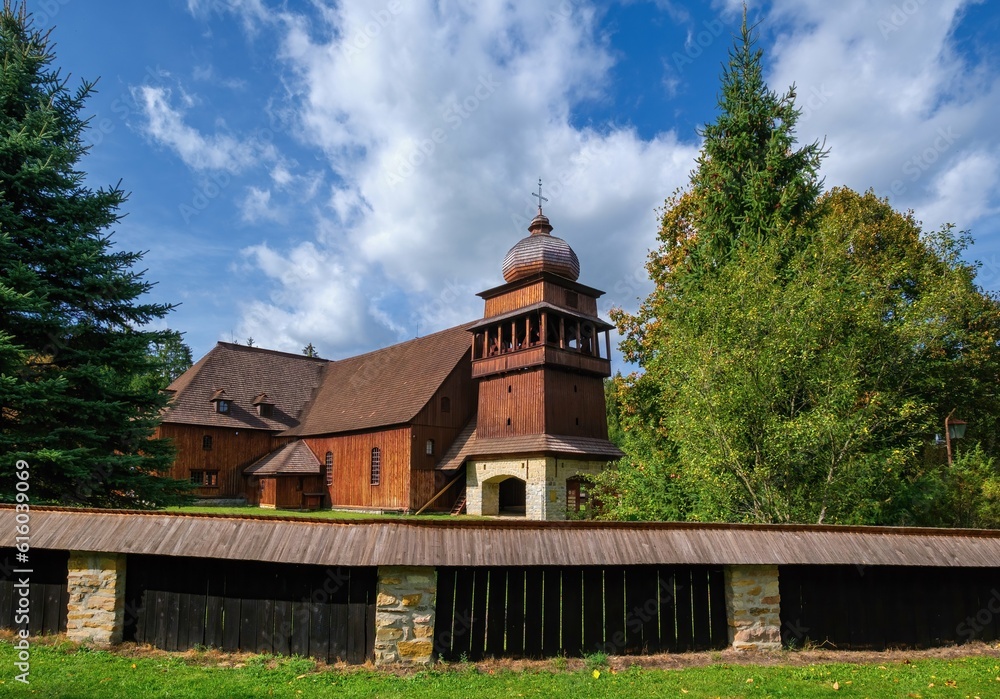 Wooden evangelical articular church of the Svaty Kriz(Holy Cross), is one of the largest wooden churches in Europe.Green meadow, blue sky white clouds, old architecture. Paludza, Svaty Kriz.