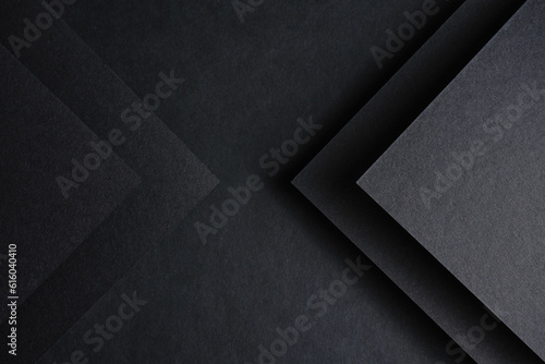 dark background on black paper with an image of triangles on both sides